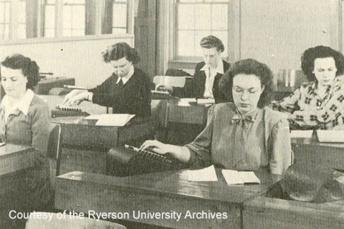 an archival photo of six women studying at their desks